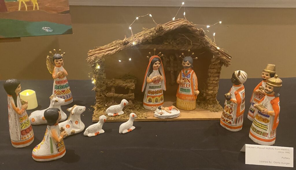 A nativity scene made from pottery. Alongside Mary, Joseph, and Baby Jesus, the three wise men, shepards, an angel, and some sheep are depicted.